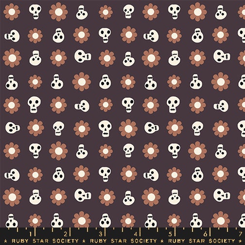 a pattern of skulls and flowers on a black background