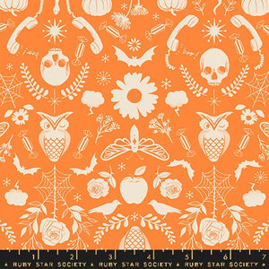 an orange and white pattern with skulls and flowers